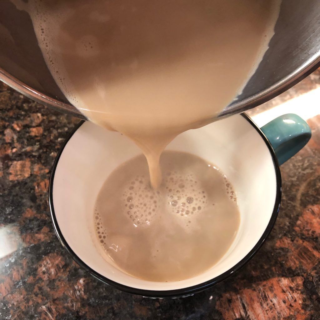 Tazo chai organic latte being poured into a cup