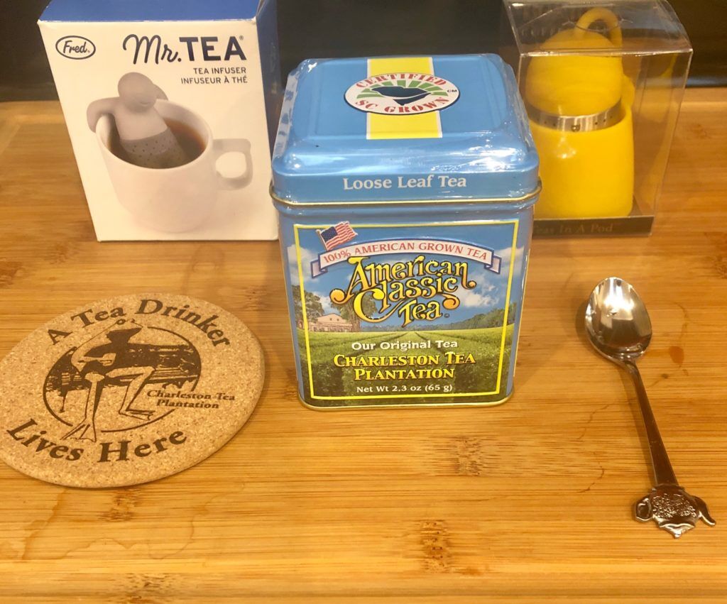 Mr Tea infuser box, American Classic Tea container, Bonjour tea infuser in plastic wrapping, A Tea Drinker Lives Here-tea coaster, tea spoon with a kettle decoration on top.