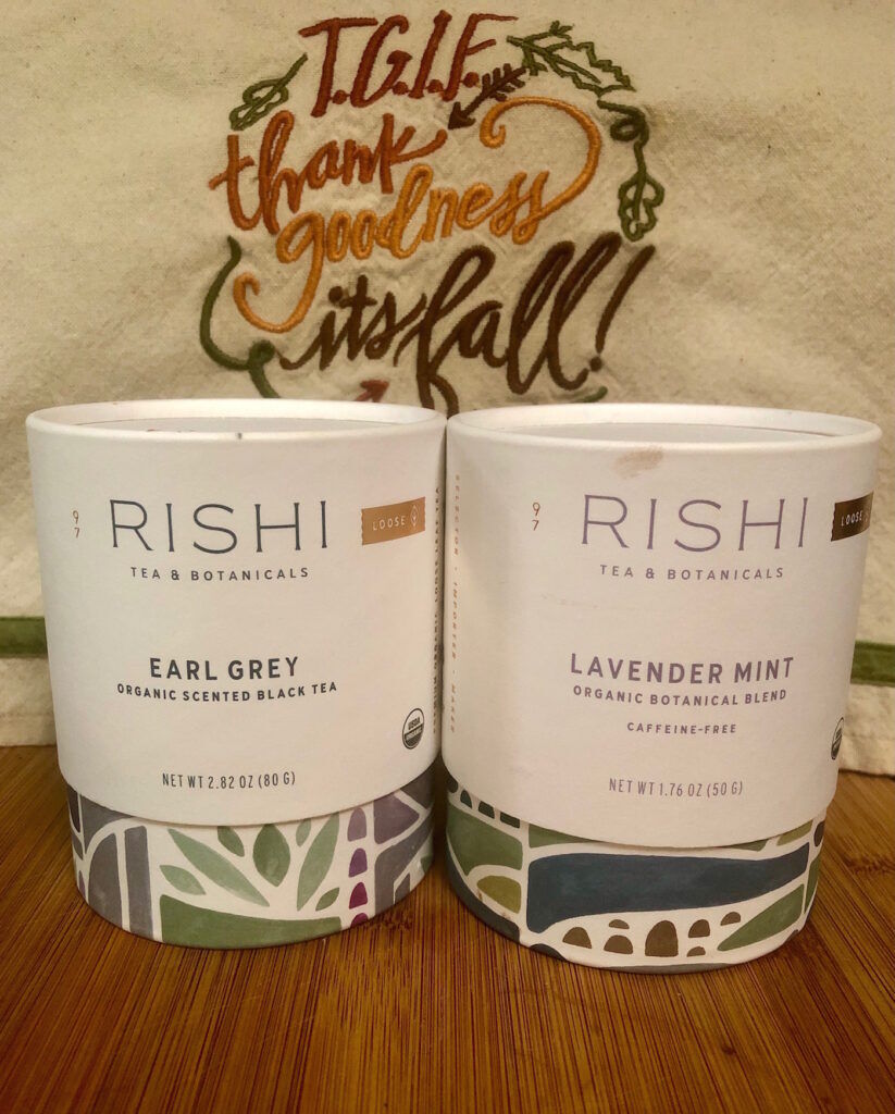 Rishi Earl Grey tea and Lavender Mint botanical blend in front of a TGIF Thank Goodness Its Fall towel