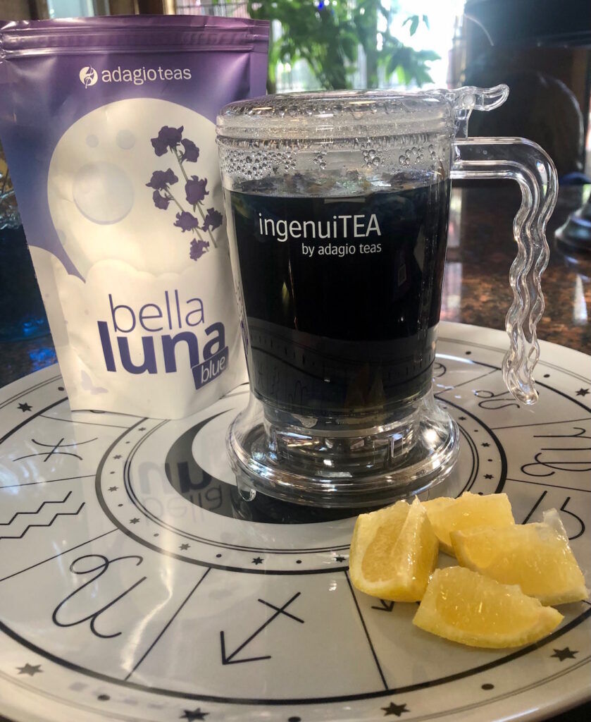 Adagio Bella Luna Blue herbal blend tea package, ingenuiTEA teapot with lemons on a plate
